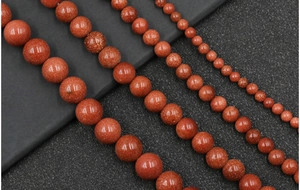 Macro detail of sparkling goldstone round beads in four sizes for DIY jewelry making