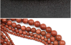 Macro shot of assorted size goldstone beads showing shimmering copper flecks for jewelry