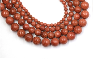 Macro view of glittering brown goldstone beads in various sizes for DIY jewelry