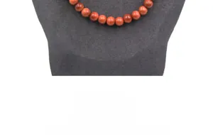 Detail of reddish-brown golden sand stone beads displayed on a jewelry mannequin
