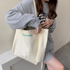 Beige canvas tote bag with green aaaaas embroidery, minimalist style for daily commute