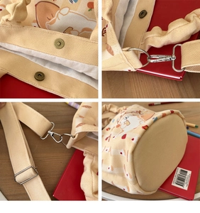 Detail view of canvas bucket bag showing magnetic clasp, adjustable strap and round base