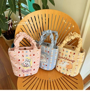 Detail of cartoon canvas tote bags with cute animal prints and ruched cloud handles