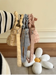 Detailed view of ruffle handle canvas bucket bags with cute cupcake prints and straps