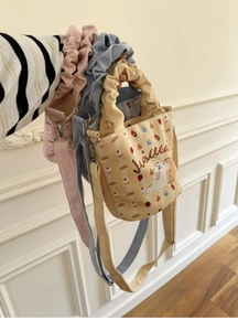 Three colorful mini canvas bucket bags with cartoon cat print and ruffled handles