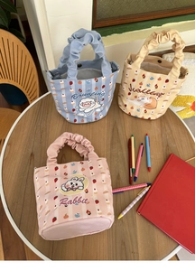 Close-up of cute cartoon canvas tote bags with ruffled cloud handles and animal prints