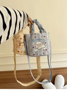 Detail of cartoon sheep canvas bucket bag with ruffled handle and adjustable strap