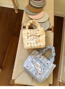 Detail view of cute cartoon cat and sheep canvas bucket bags with unique ruched handles