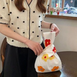 Japanese knot bag with orange floral print, minimalist cotton wrist pouch for daily use