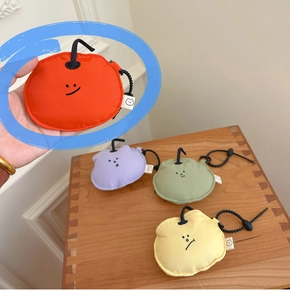 Detailed view of colorful fruit-shaped earphone pouches with cute face expressions