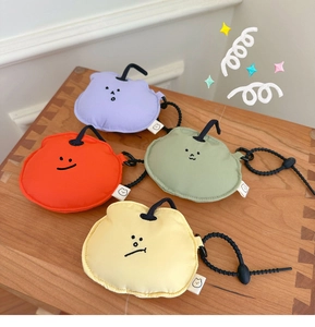 Detail of colorful mini headphone pouches with minimalist faces and adjustable lanyards