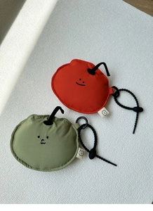 Detail of red and green soft fabric earphone pouches with cute face embroidery and hooks