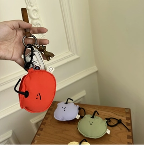Detail of colorful soft protective earphone cases with leather handles and metal clips