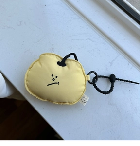 Detail of soft pale yellow protective earphone pouch with drawstring and cute embroidery