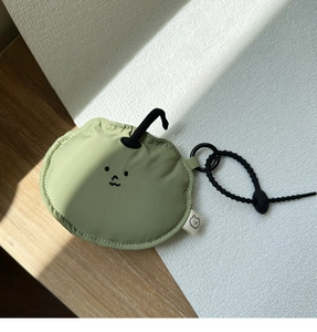 Close-up of light green padded earphone case with cute embroidery and metal clip