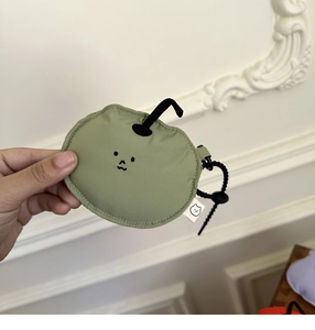 Close-up of green apple fruit shaped earphone case with lanyard and metal clasp