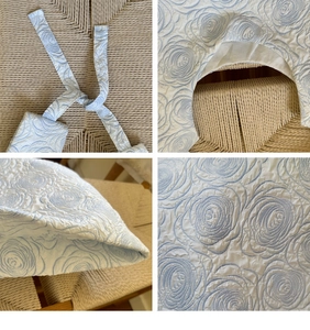 Close-up of light blue floral embossed canvas bag with tie-dye and jacquard details