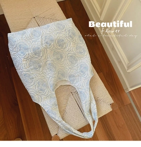 Detail of light blue floral embossed texture on a white canvas tote bag for yoga