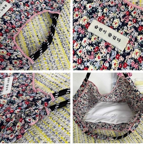 Detail view of floral cotton canvas tote bag with woven handles and internal zipper pocket