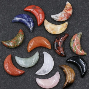 Set of 30mm moon-shaped natural crystals including rose quartz and tiger eye stones.