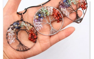Macro detail of handmade copper wire wrapped Tree of Life pendant with natural crystal stones