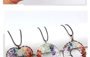 Close-up of handmade tree of life pendants with natural healing crystal stone beads
