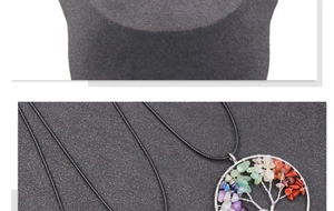 Detailed close-up of a Tree of Life pendant featuring colorful natural crystal stones