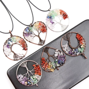 Handmade tree of life pendant with natural stones and copper wire wrapping on black background