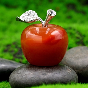 Red quartz apple ornament with silver leaves on mossy stones for Christmas gift