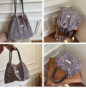 Detail of floral tote bag with striped rope handles and pink piping on canvas