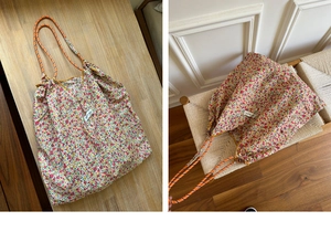 Detail of floral tote bag showing colorful patterns and durable rope handle with eyelets