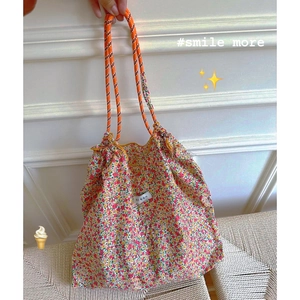 Floral canvas tote bag with orange rope handles and red yellow pink flower pattern