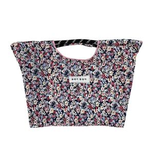 Large floral canvas tote bag with colorful pattern and striped handles on white background