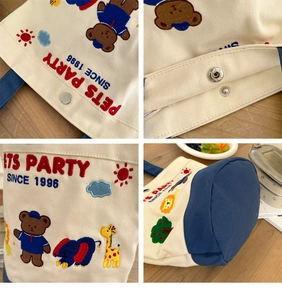 Detail of canvas lunch bag featuring animal embroidery and silver magnetic closure