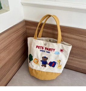 Detailed embroidery of cartoon animals and Pets Party text on a canvas tote bag