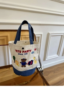 Detail of canvas tote bag featuring animal embroidery and PETS PARTY text logo