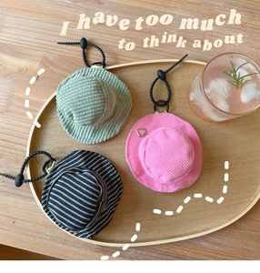 Mini fisherman hat shaped coin purses with elastic lanyards displayed on a wooden tray