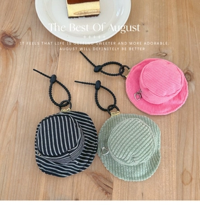 Mini corduroy bucket hat pouch detail with heart zipper and coffee shop background