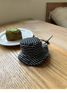 Miniature black and white striped bucket hat bag charm with adjustable drawstring