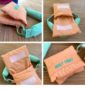 Detailed view of quilted orange pouch with mint green strap and Velcro closure