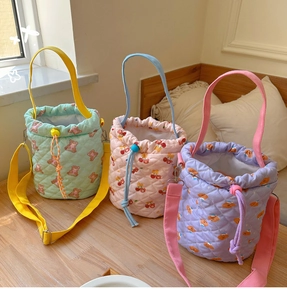 Quilted pastel bucket bags in mint, pink, and purple featuring cute cartoon prints