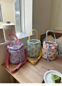 Quilted pastel bucket bags with cute cartoon patterns and adjustable shoulder straps