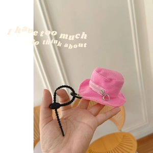 Pink corduroy bucket hat coin purse with heart zipper and clip, held in hand