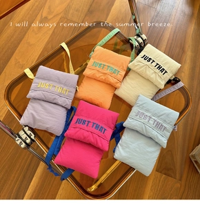Detailed view of colorful quilted crossbody mini phone bags in 5 pastel nylon colors