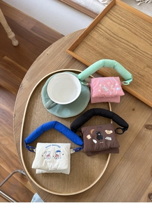 Detailed view of quilted animal print mini pouches in pink, brown and white colors