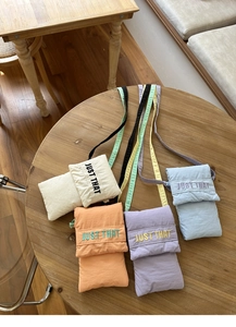 Detailed embroidery on colorful nylon crossbody bags in cream, orange, and blue colors