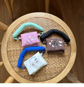 Detailed view of three mini fabric shoulder bags with cartoon animal prints and thick straps