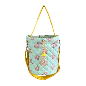 Quilted light green bucket bag with brown bear prints and yellow straps for women