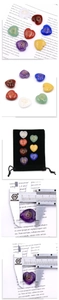 Macro detail of seven heart-shaped chakra stones with golden symbols and sizing measurements