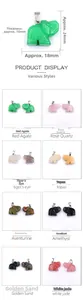 Detail view of 24mm carved natural gemstone elephant pendants in multiple colors